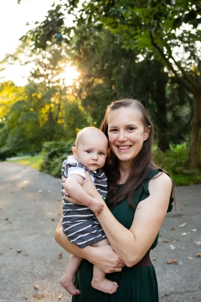 Mom cuddles her infant sun on a beautiful summer evening.